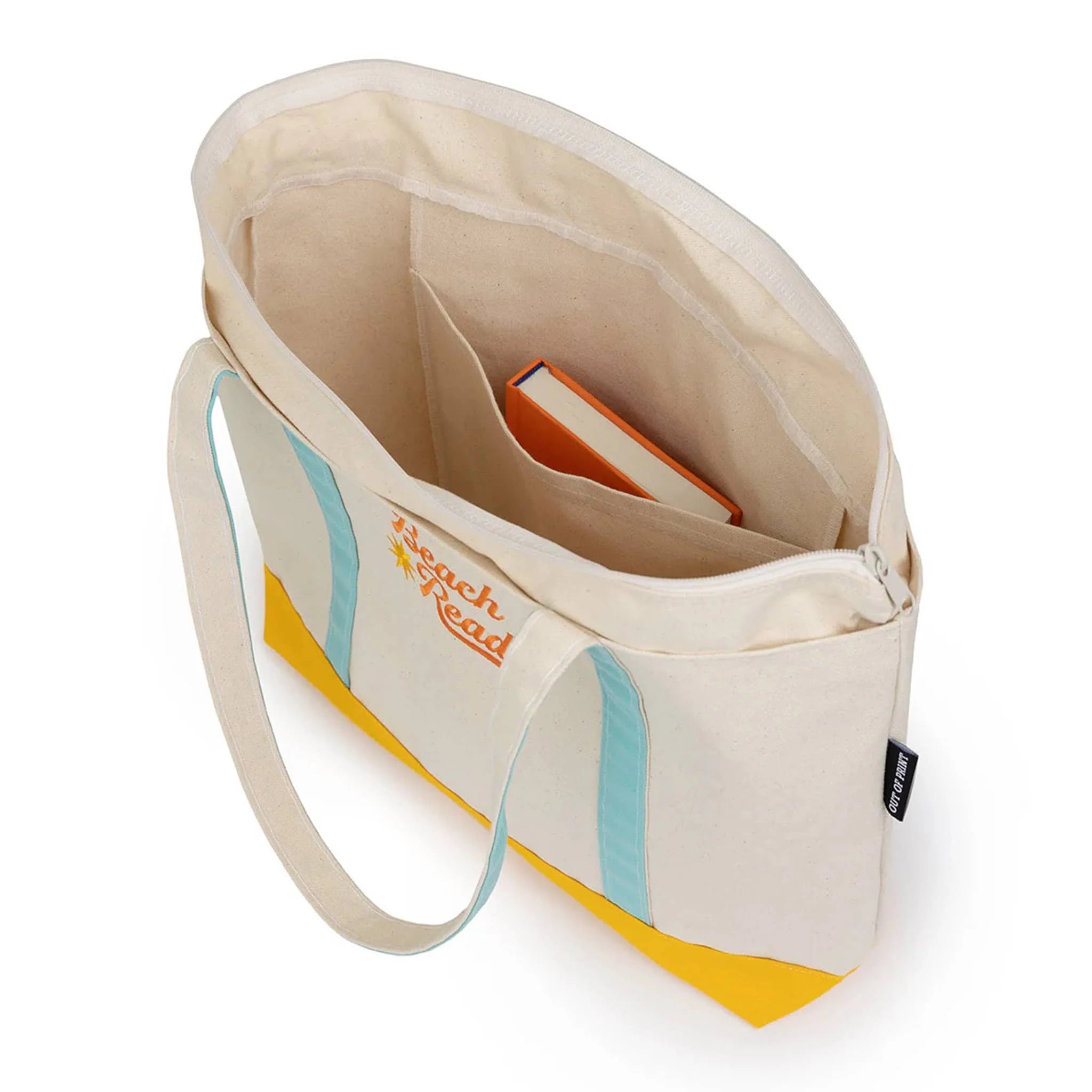 out-of-print-TOTE-1141-beach-reads-zippered-boat-tote-bag-overhead-9780593896143.webp